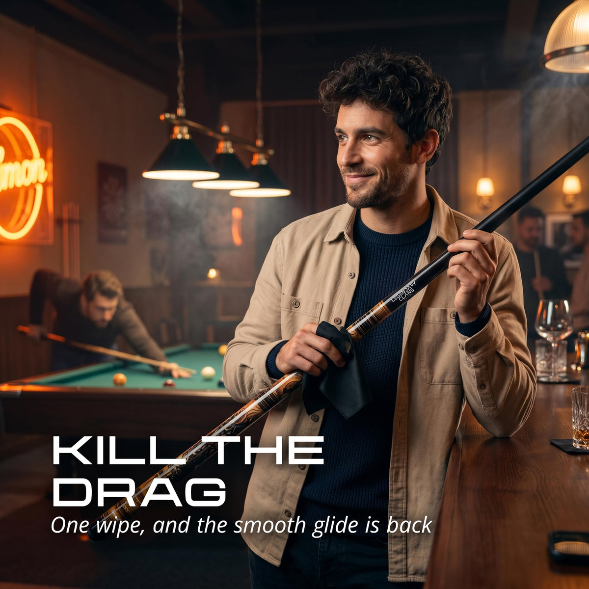 Player wiping the IgnatGames Brassbolt pool cue shaft with a cloth in a pool hall