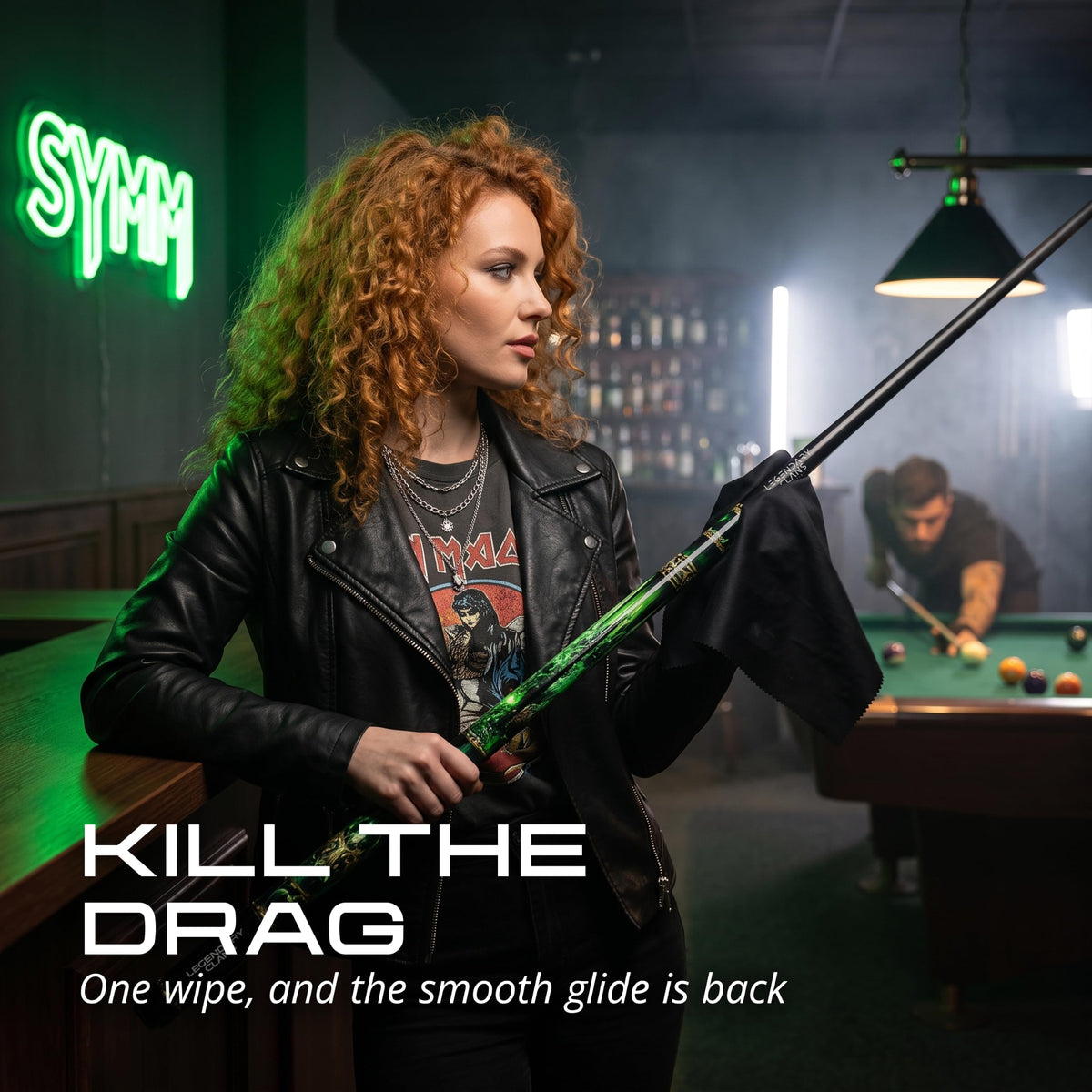 Player wiping the IgnatGames Wildstrike pool cue shaft with a cloth in a pool hall